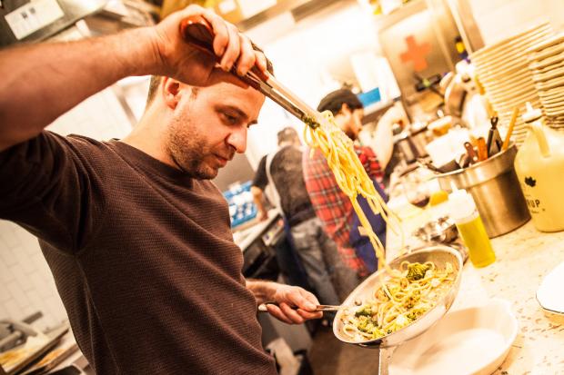  Chef Hugue Dufour prepares a plate of peanut butter shrimp pasta on Jan. 22, 2013. 